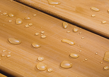 Deck boards with water beading in a light color.