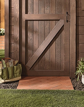 Shed door and wooden mat stained in different tones. 