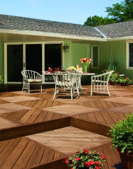 Parquet-style deck stretching back to green ranch house.