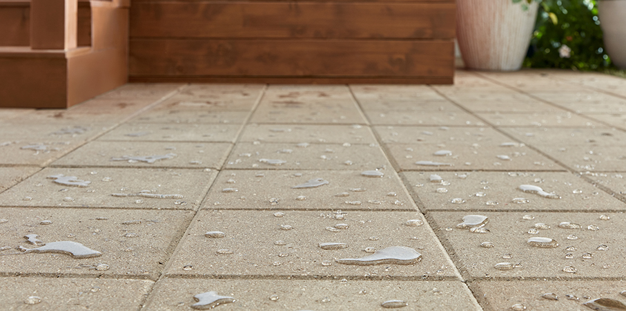 Concrete patio pavers with beading water that proves Thompson’s WaterSeal Clear Multi-Surface Waterproofer is on the job