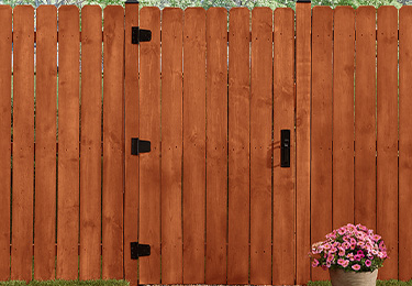 A tall fence makes a statement in Thompson’s WaterSeal Semi-Transparent Wood Protector in Sedona Red