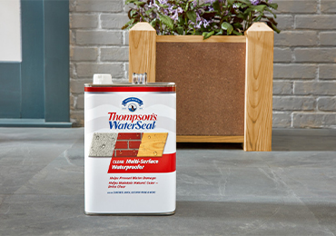 Wooden planter on concrete patio, both protected with Thompson’s WaterSeal Clear Multi-Surface Waterproofer
