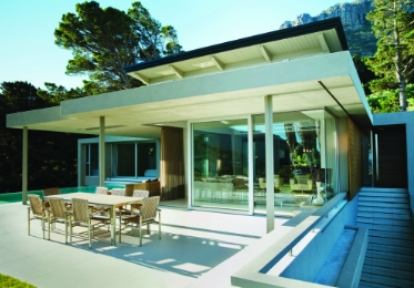 Expansive modern patio in concrete with dining set. 