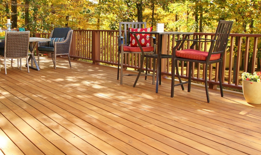 Large sunlight-dappled fence with inviting seating and planter.
