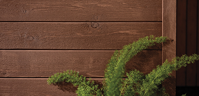 Horizontal wood siding in a dark brown color. 