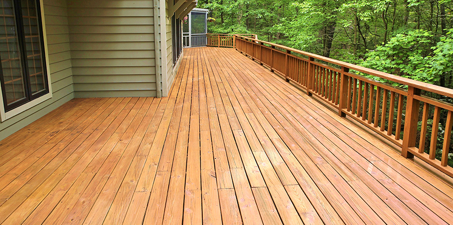 Large deck and green house in the woods. 