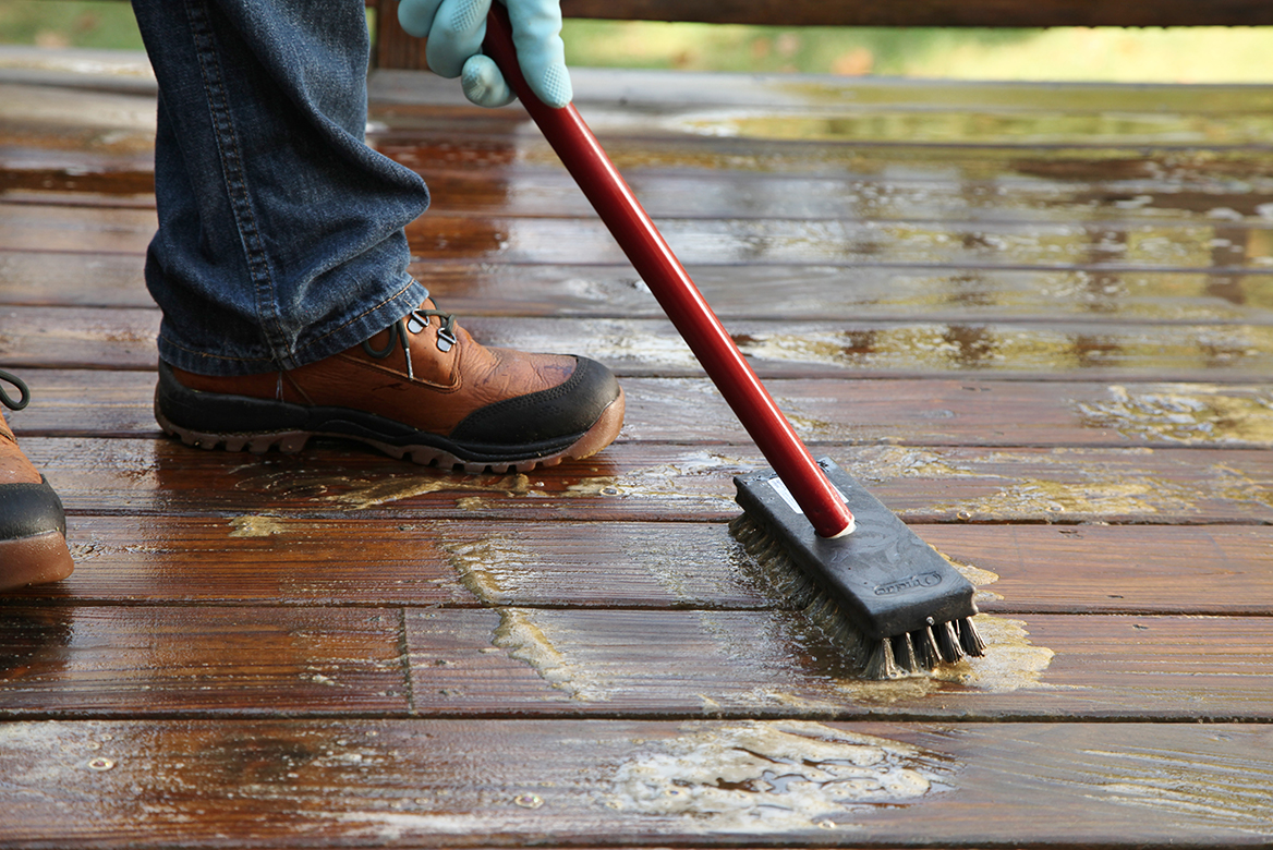 Man Cleaning Deck Prior to Staining
