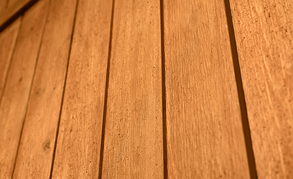 Close-up view of stained fence with visible wood grain. 